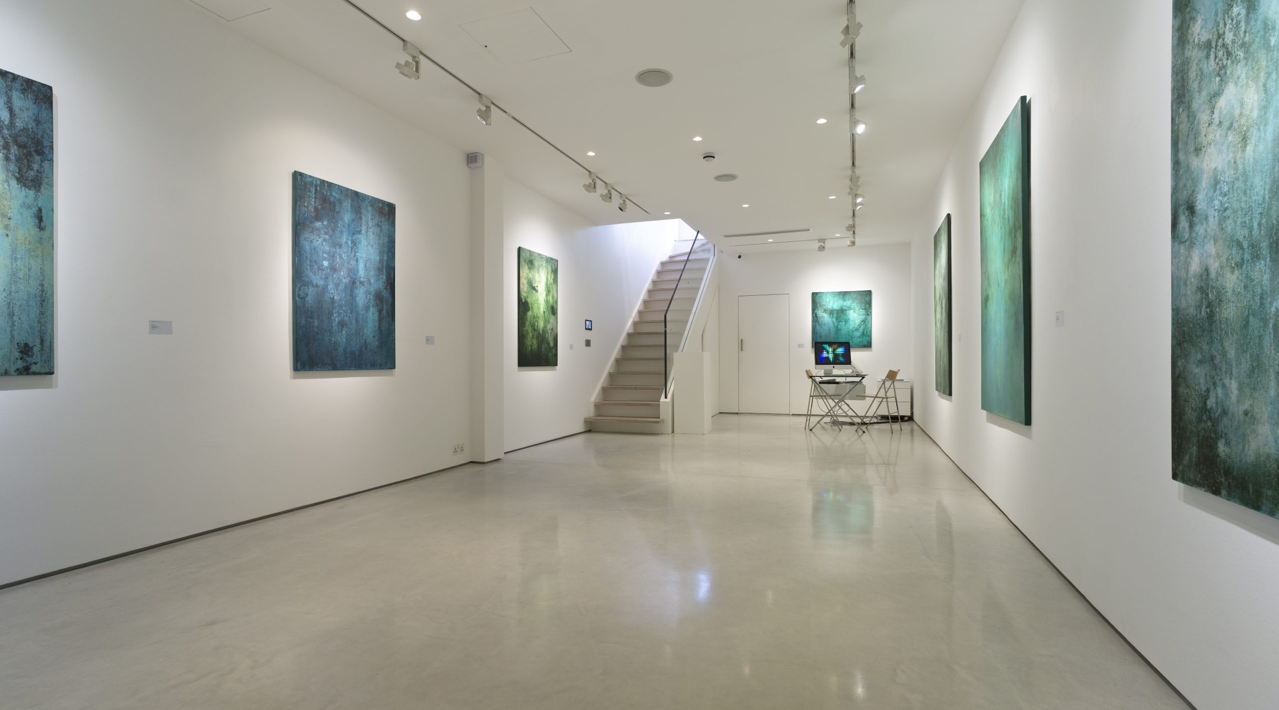 Modern gallery with polished concrete floors, showcasing HATCRETE's finish systems in a sleek exhibition space.